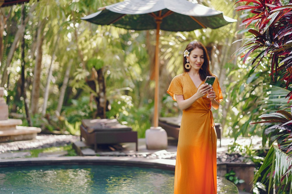 Woman in Pool Checking Indonesia eSIM for Bali Connectivity